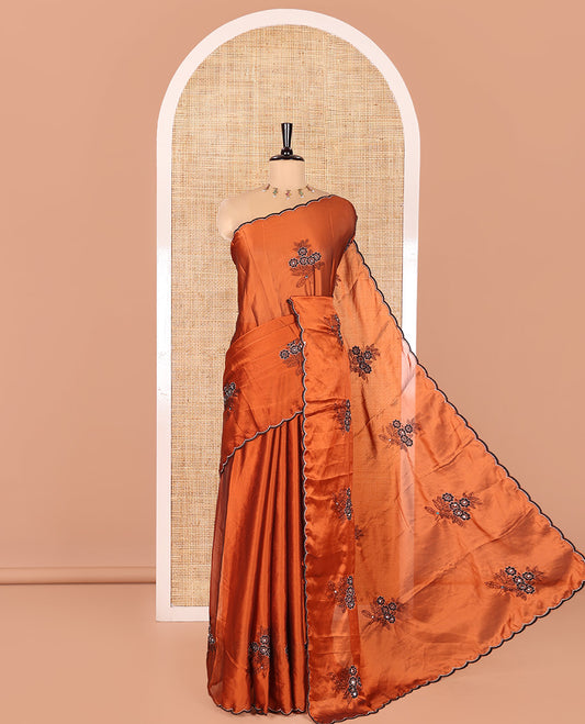 Rust Rangoli Chiffon Saree, Adorned with Flower-Style Motifs Embroidered on Its Body, a Subtle Scallop Embroidered Border, a Self-Pallu, and Paired with a Contrast Embroidered Blouse
