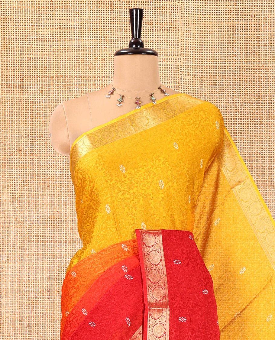 Yellow and Red Candy Chiffon Saree, Decked Up with Floral Vine Embossed, Buttas, and Ombre-Style Dyed on Its Body, Highlighted by Floral Creeper Zari Border, Intricately Designed Pallu, and Paired with a Contrast Blouse