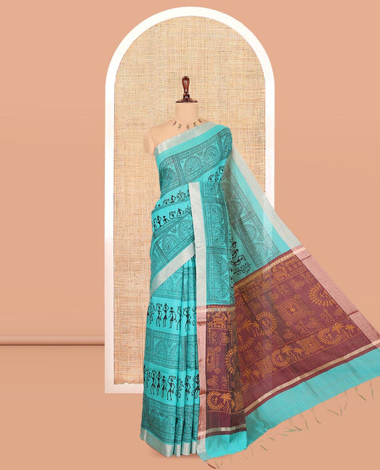 Teal Green Semi-Silk Cotton Saree, Adorned with Warli Print, a Tissue Border, Contrast Warli Printed Pallu, and a Contrast Blouse
