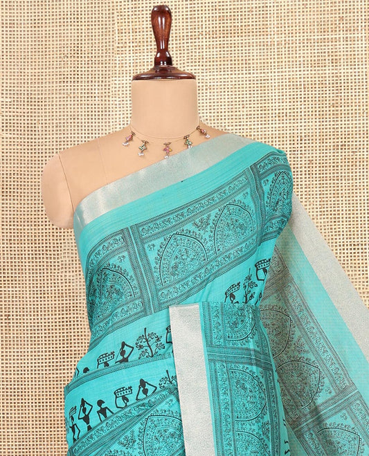 Teal Green Semi-Silk Cotton Saree, Adorned with Warli Print, a Tissue Border, Contrast Warli Printed Pallu, and a Contrast Blouse