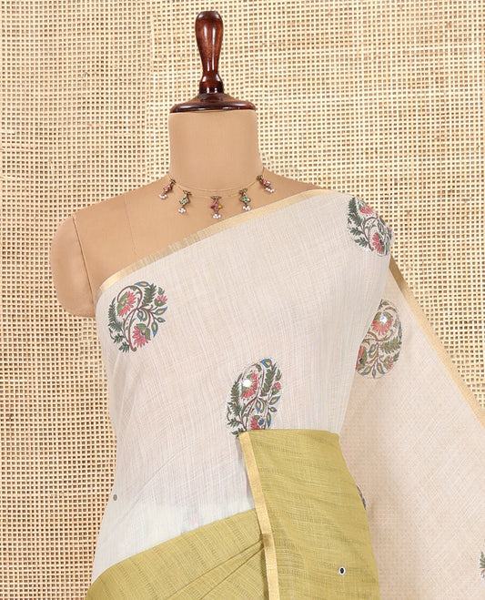 Cream-Green Linen Cotton Saree Features a Half-And-Half-Style Floral Butta and Mirror Work, a Piping Border, a Contrast Blouse