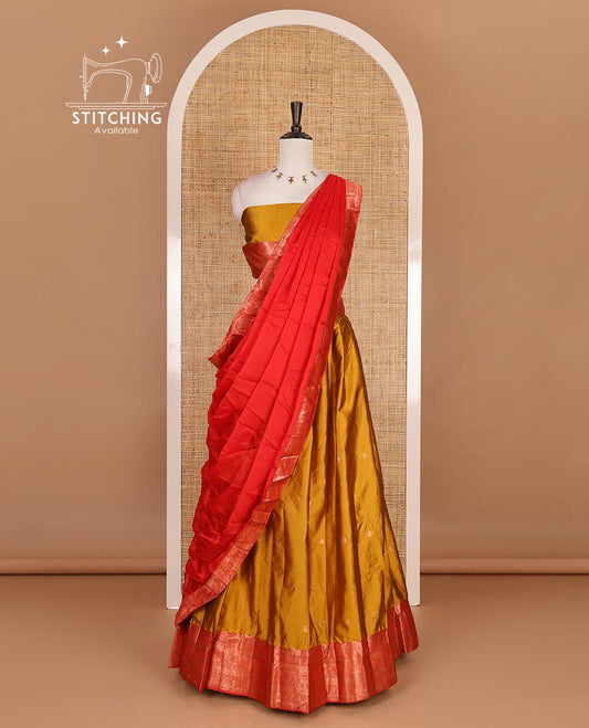 Mustard taffeta silk half saree, zari buttas with contrast red traditional zari border, matching zari blouse, and contrast plain zari border dhavani