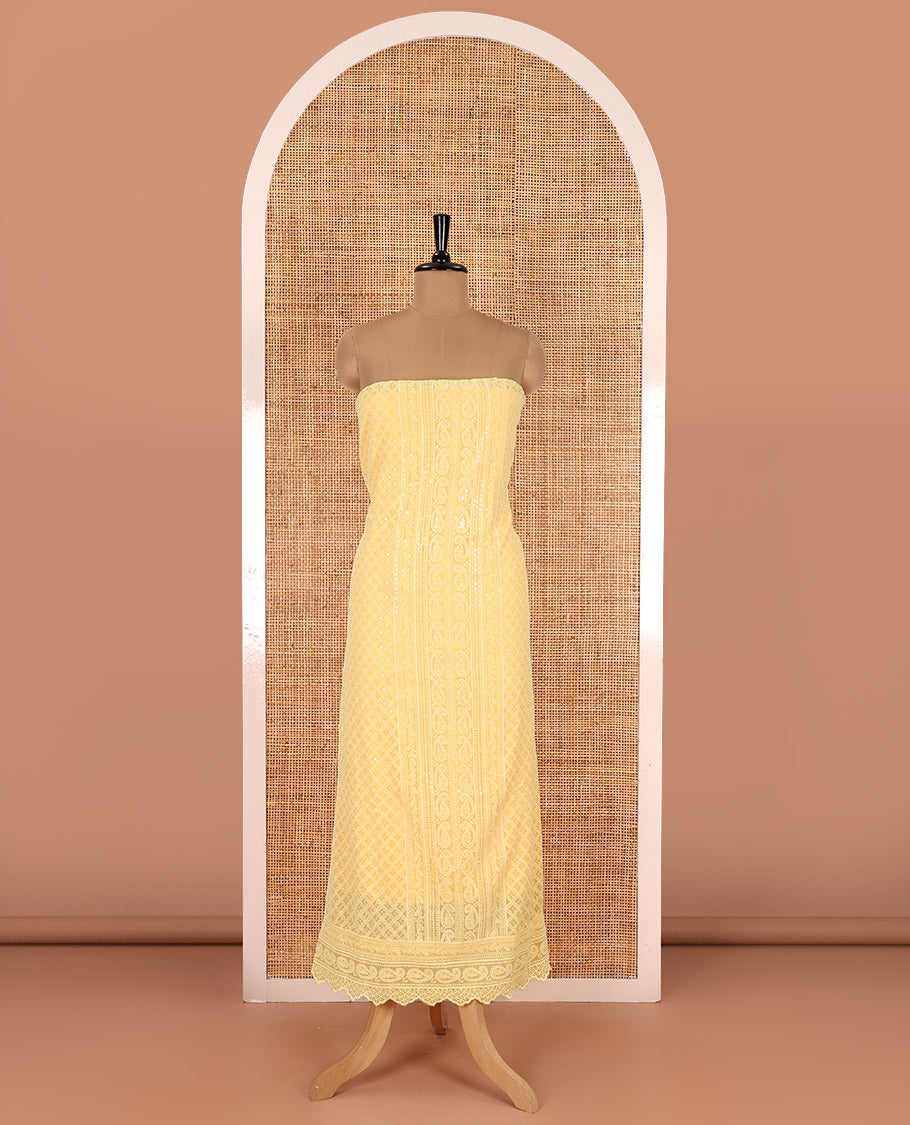 Yellow material chudidar set, paisleys and jaal schiffli sequins embroidered mul georgette top, a matching bottom, and a mirror work dupatta