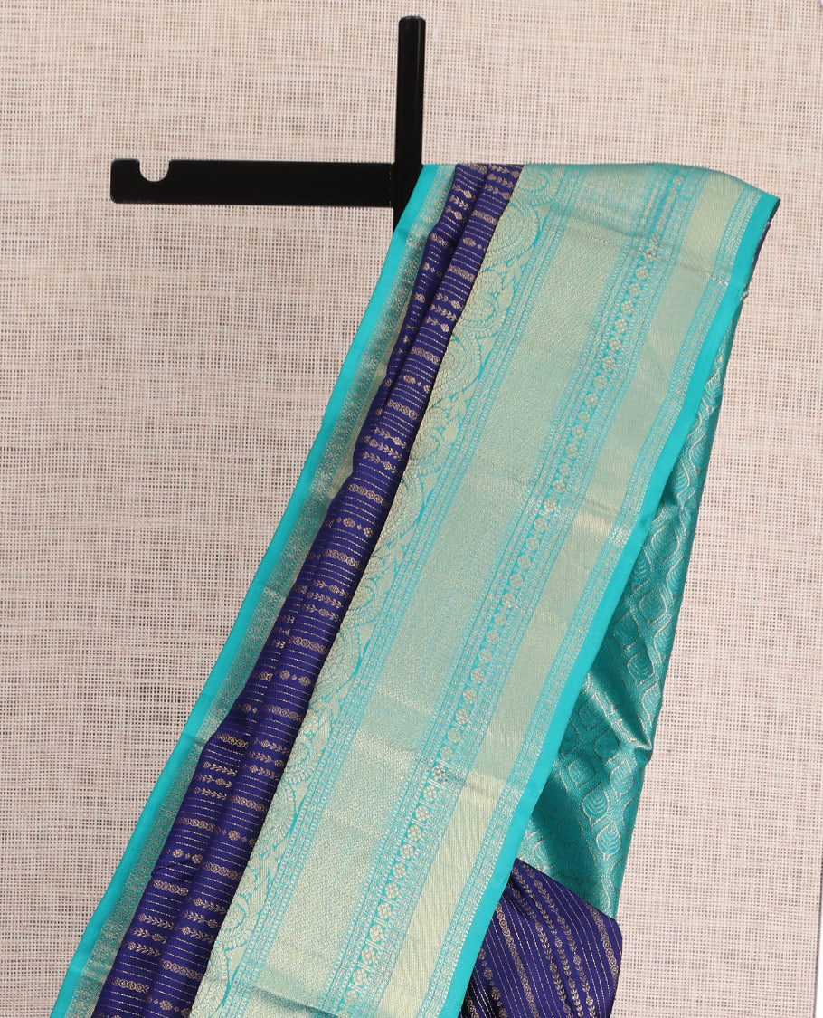 Blue Vasundhara Silk Saree Adorned with Jacquard Design Weave All Over Its Body, Complemented by a Contrast Border of Rekku, Muthu, Laddu Kamalam, Then Kuli Kann, and Dhavana Kodi Designs, Artfully Zari Woven Pallu, and Paired with a Contrast Blouse