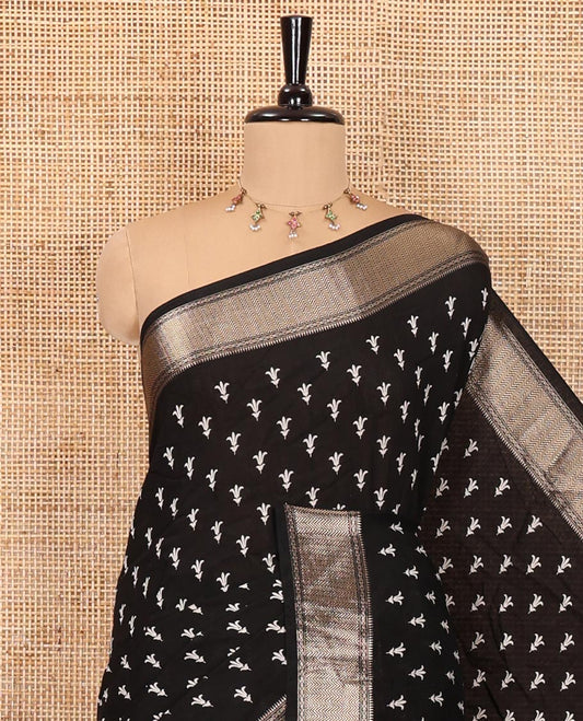 Black floral buttas discharge printed assam silk saree, chevron striped zari border, zari striped pallu, and a matching blouse