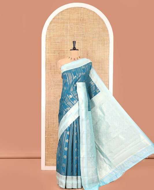 Peacock Blue Litchi Saree, Elevated with Vaira Oosi Stripes and Zari Buttas on Its Body, Complemented by a Contrast Rettai Pettu Traditional Zari Design Border, an Intricately Designed Pallu, and Paired with a Contrast Blouse
