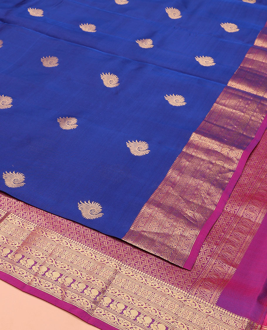Blue Vasundhara Lite-Silk Mix Saree, Adorned with Zari Buttas, Complemented by Contrast Border Featuring Thilakam Mokku, Kodi Visiry, Muthu, Laddu Kamalam, and Mayil Designs, Grandly Pallu of Scallop Designs, and Paired with a Contrast Blouse
