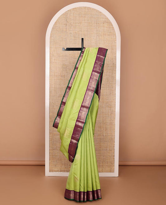 Green silk saree with box mayil and chakram buttas, contrast border of thilakam mokku,muthu,kathir & yaanai designs & jaal pallu