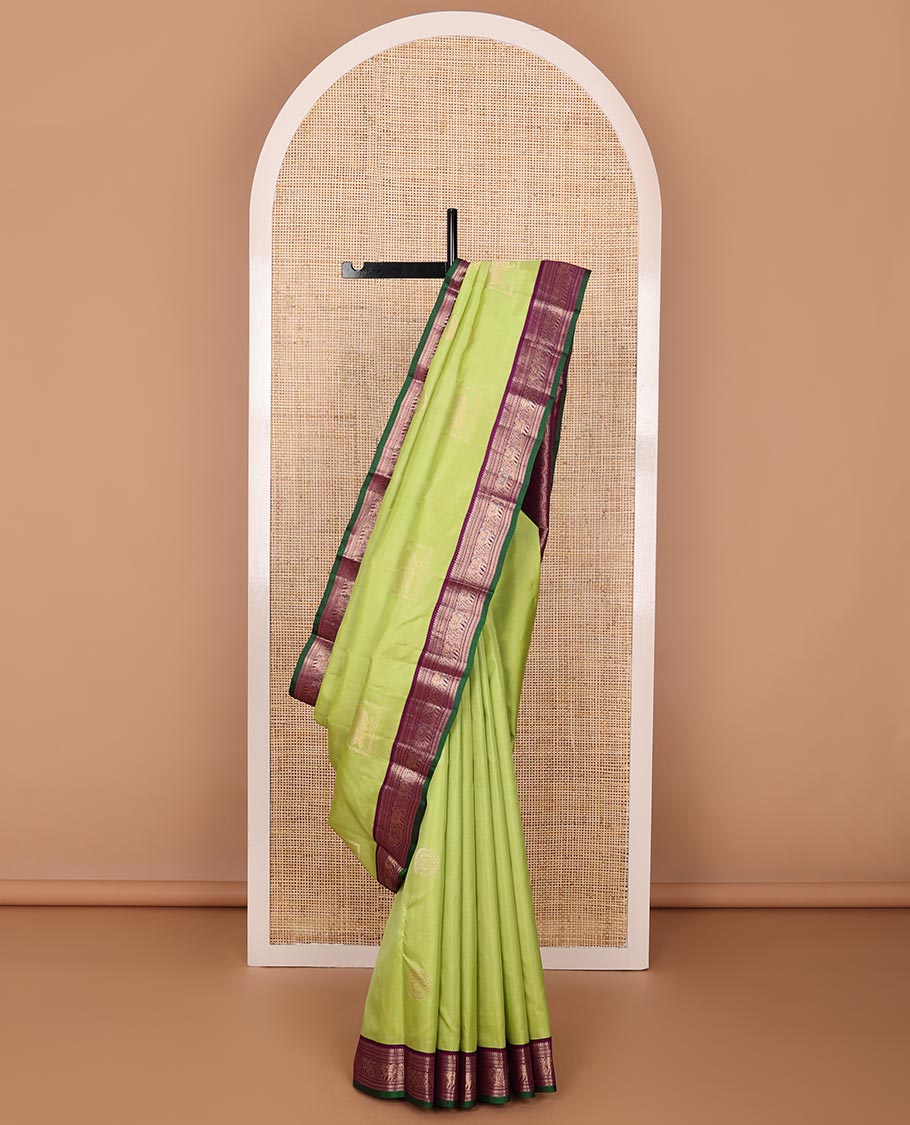 Green silk saree with box mayil and chakram buttas, contrast border of thilakam mokku,muthu,kathir & yaanai designs & jaal pallu