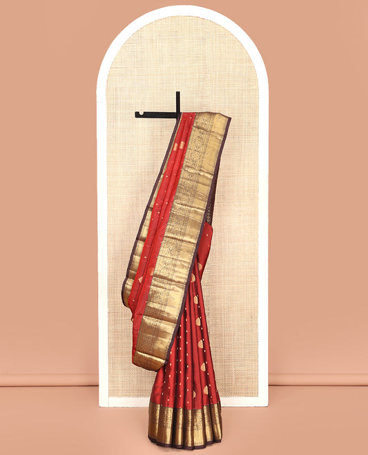 Orange Vasundhara Silk Saree, Decked Up with Zari Buttas All Over Its Body, Complemented by Contrast Border of Rekku Poun, Muthu, and Floral Designs, Grand Jaal Pallu and Paired with a Contrast Blouse