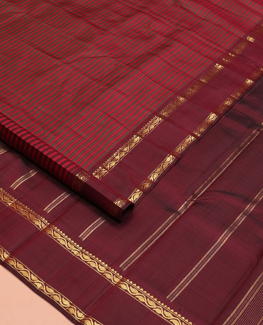 Red striped Kanchipuram silk saree, contrast rettai pettu border of rekku, muthu, and leaf creeper designs, and zari striped pallu