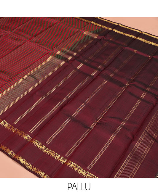 Red striped Kanchipuram silk saree, contrast rettai pettu border of rekku, muthu, and leaf creeper designs, and zari striped pallu