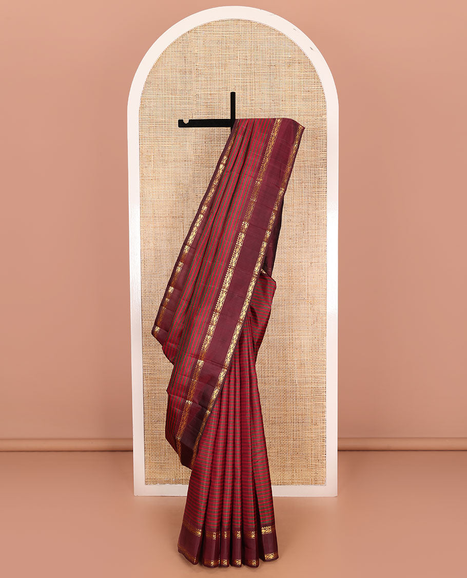 Red striped Kanchipuram silk saree, contrast rettai pettu border of rekku, muthu, and leaf creeper designs, and zari striped pallu