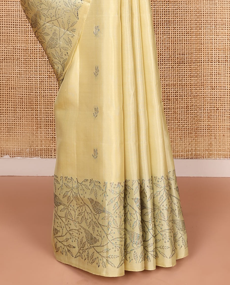 Pastel yellow floral buttas soft silk saree, floral-bird design border, and intricately designed pallu