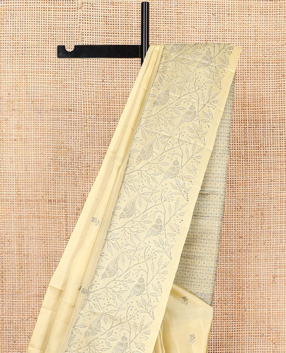 Pastel yellow floral buttas soft silk saree, floral-bird design border, and intricately designed pallu