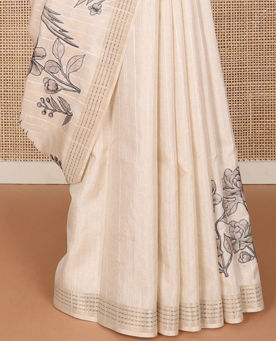 Cream printed tussar saree mirrors the bird on the floral branches design, has a zari border & zari striped pallu