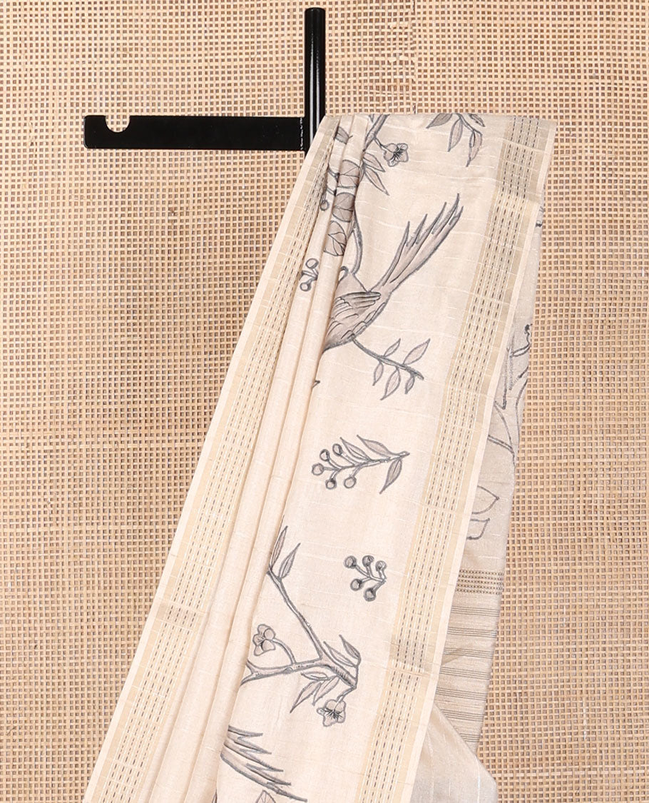 Cream printed tussar saree mirrors the bird on the floral branches design, has a zari border & zari striped pallu