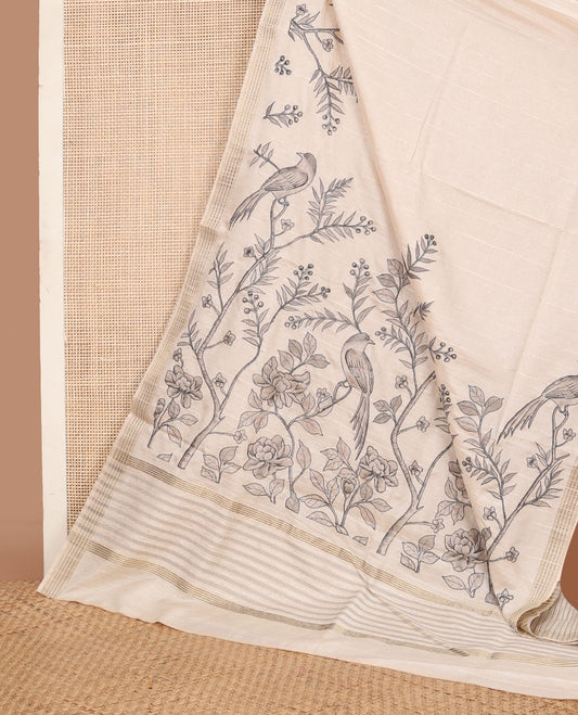 Cream printed tussar saree mirrors the bird on the floral branches design, has a zari border & zari striped pallu