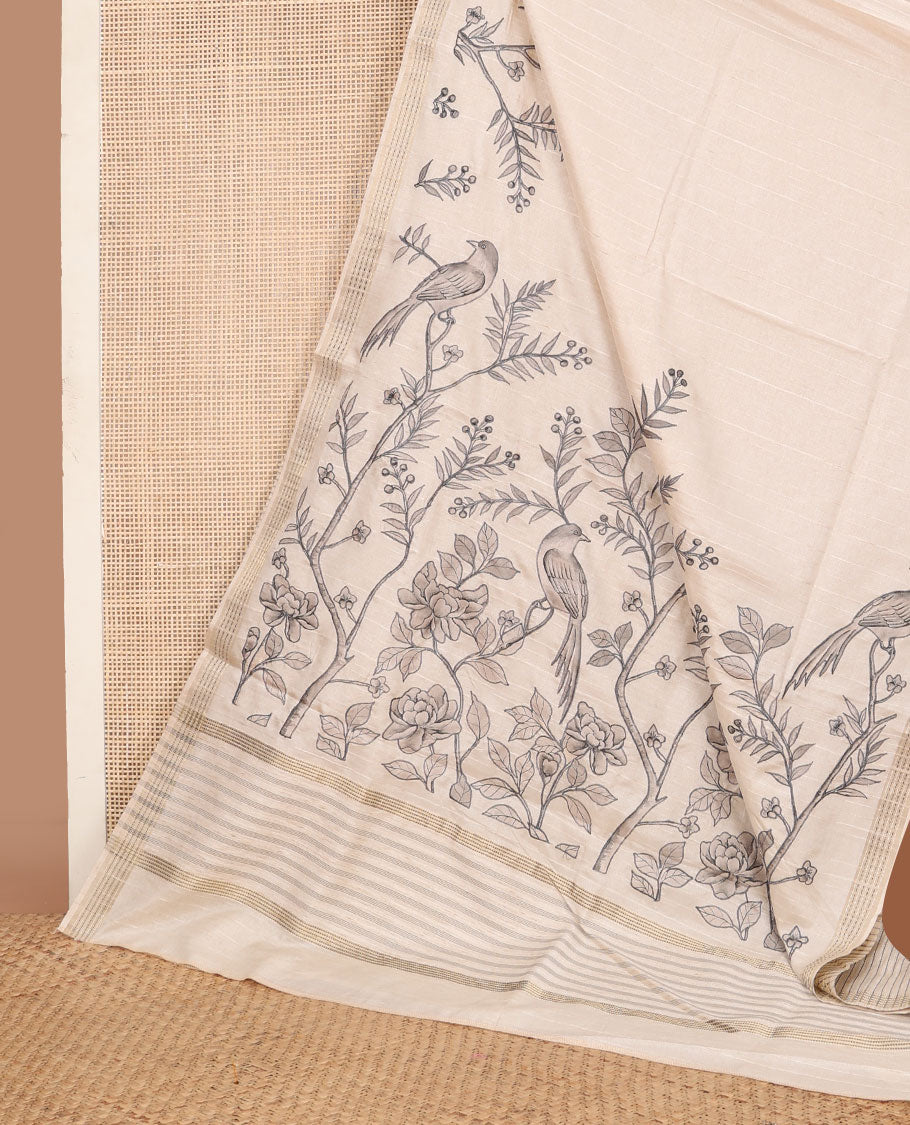 Cream printed tussar saree mirrors the bird on the floral branches design, has a zari border & zari striped pallu
