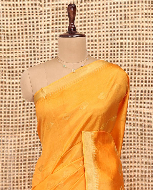 Yellow Banana Pith Saree, Sparsely Sparkled with Buttas All Over Its Body, Highlighted by Temple Zari Border, Pallu Steeped with Stripes, and Paired with a Matching Blouse