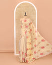 Gold and pink rose motifs printed with mirror work tissue saree, scallop embroidered border, printed pallu, and a contrast blouse