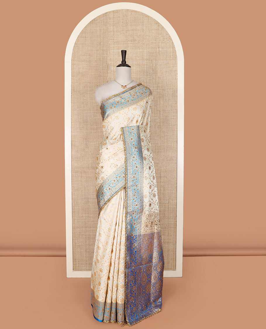 Cream Art Vastrakala Silk Saree Enthralled with Floral Jaal Jacquard with Stone Work All Over Its Body, Complemented by a Contrast Floral Creeper Zari Stone Work Border, Pallu Detailed in Zari and Stone Work, and Paired with a Contrast Blouse