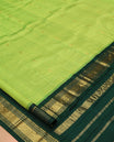 Green Kanchipuram Silk Saree, Subtly Woven with Zari Buttas, Complemented by a Contrast Korvai Border of Rekku, Banaras, Muthu, and Mayil Kann Design, Zari Design Pallu, and No Blouse