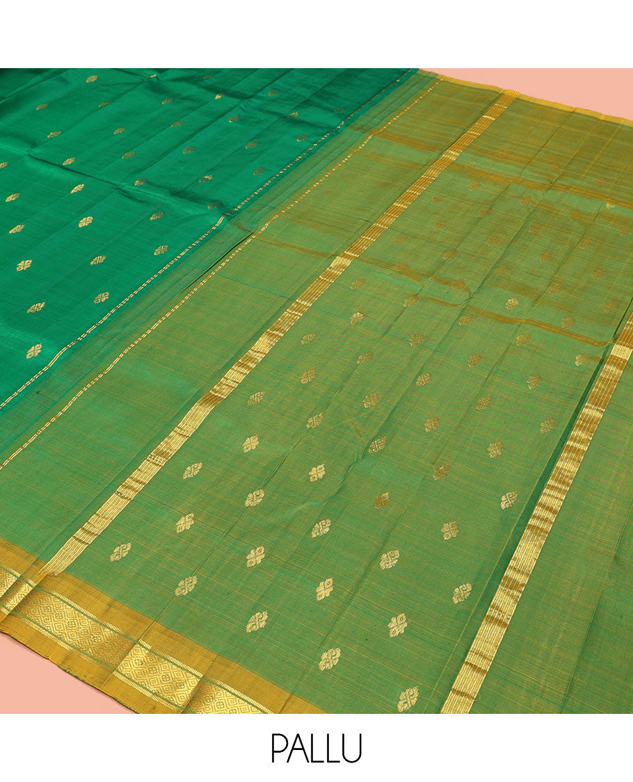 Green Kanchipuram Silk Saree, Decked Up with Zari Buttas, a Contrast One-Sided Border of Banaras and Muthu Design, Zari Design Pallu, and No Blouse