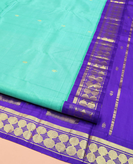 Turquoise Kanchipuram Silk Saree, Beautified with Zari Buttas on Its Body, Complemented by a Contrast One-Sided Korvai Border of Vanki, Banaras, and Rudraksham Designs, Pallu of Zari Designs, and Comes Without a Blouse