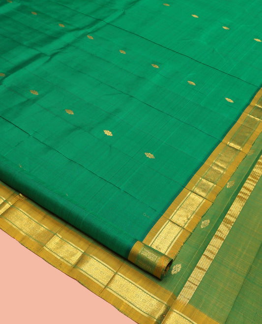Green Kanchipuram Silk Saree, Decked Up with Zari Buttas, a Contrast One-Sided Border of Banaras and Muthu Design, Zari Design Pallu, and No Blouse