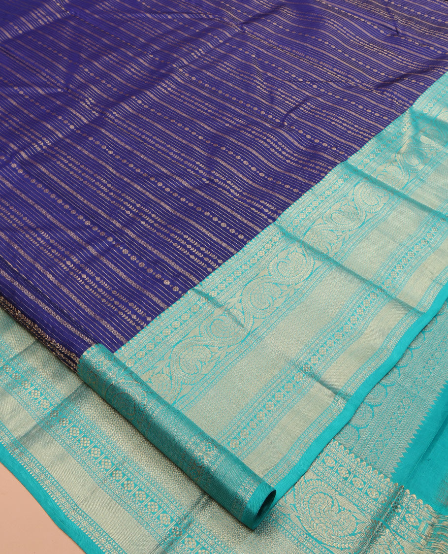 Blue Vasundhara Silk Saree Adorned with Jacquard Design Weave All Over Its Body, Complemented by a Contrast Border of Rekku, Muthu, Laddu Kamalam, Then Kuli Kann, and Dhavana Kodi Designs, Artfully Zari Woven Pallu, and Paired with a Contrast Blouse