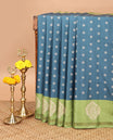 Blue with parrot green butta printed kathan silk saree with contrast floral zari border & rich printed pallu along with printed blouse