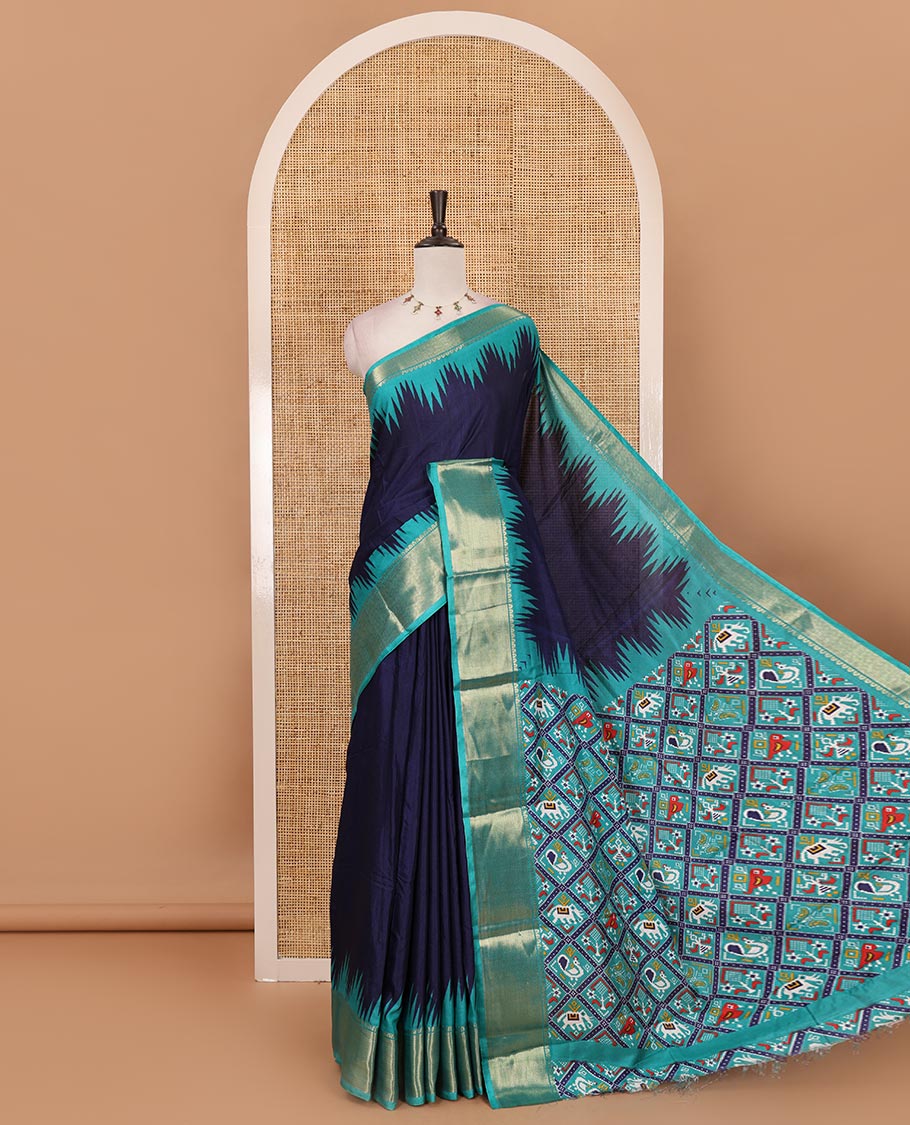 Navy blue plain dola-tussar saree, contrast temple zari border, patola animal motifs enclosed jaal printed pallu & patola printed blouse