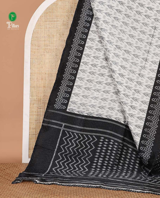 White ikat-style printed Litchi crushed saree, contrast black ikat border, pallu of ikat chevron & dots & ikat printed blouse