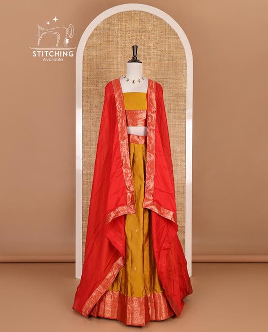 Mustard taffeta silk half saree, zari buttas with contrast red traditional zari border, matching zari blouse, and contrast plain zari border dhavani