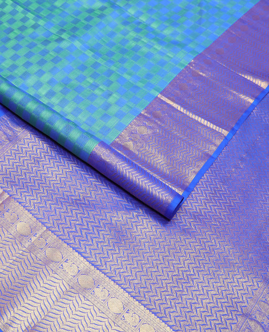 Blue checkered silk saree with contrast border of tilakam mokku, paun, mauil design & floral design pallu