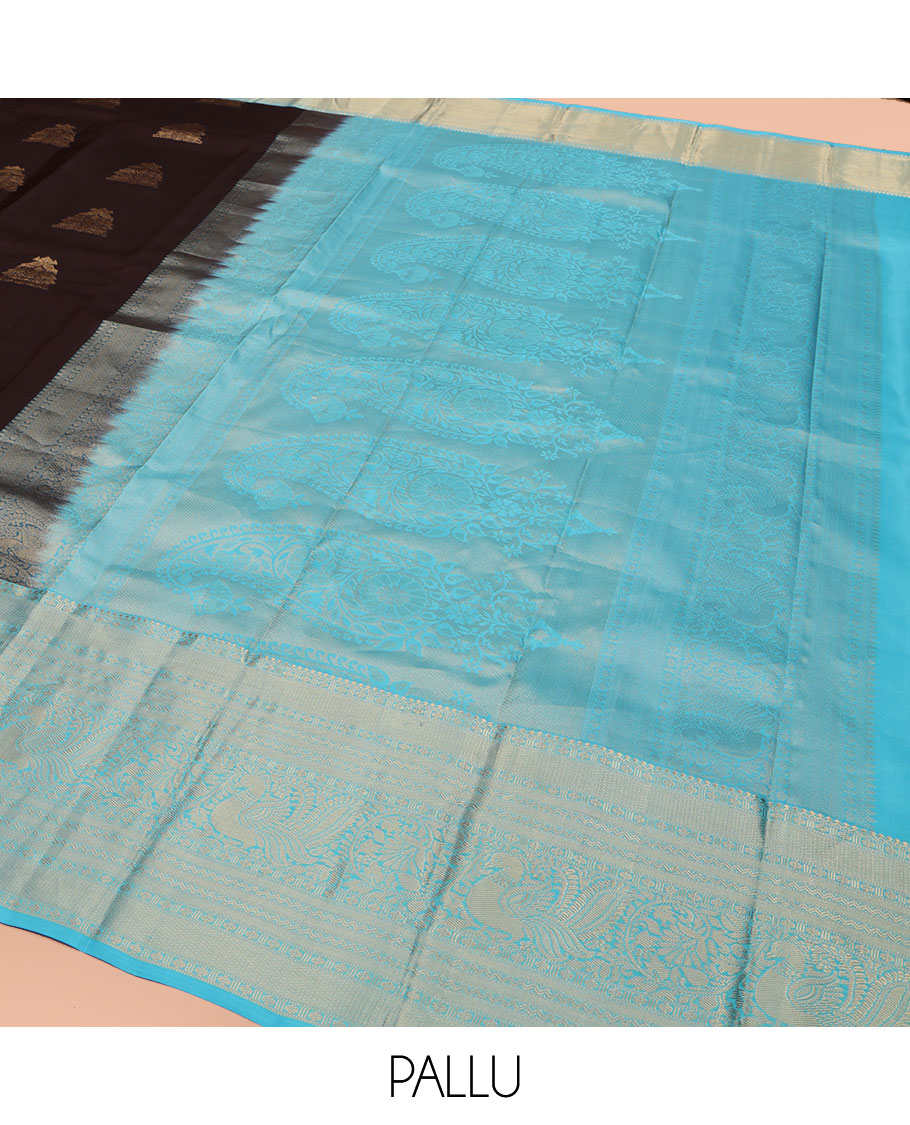 Brown Vasundhara Silk Saree, Elegantly Highlighted with Zari Buttas All Over Its Body, Complemented by Contrast Border of Salngai, Rettai Neli, Kodi Mayil, and Mayil Kann Designs, Grandly Embellished Pallu, and Paired with a Contrast Blouse