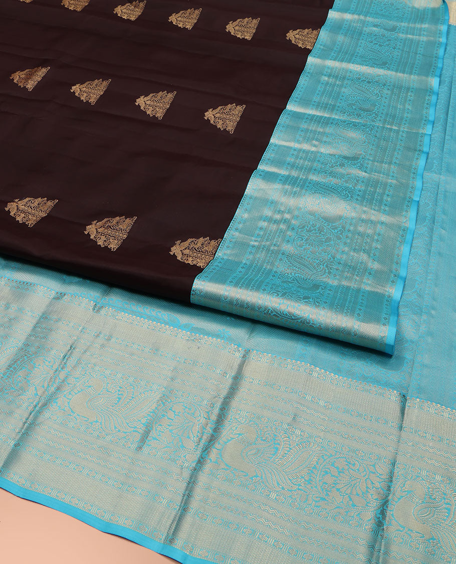 Brown Vasundhara Silk Saree, Elegantly Highlighted with Zari Buttas All Over Its Body, Complemented by Contrast Border of Salngai, Rettai Neli, Kodi Mayil, and Mayil Kann Designs, Grandly Embellished Pallu, and Paired with a Contrast Blouse
