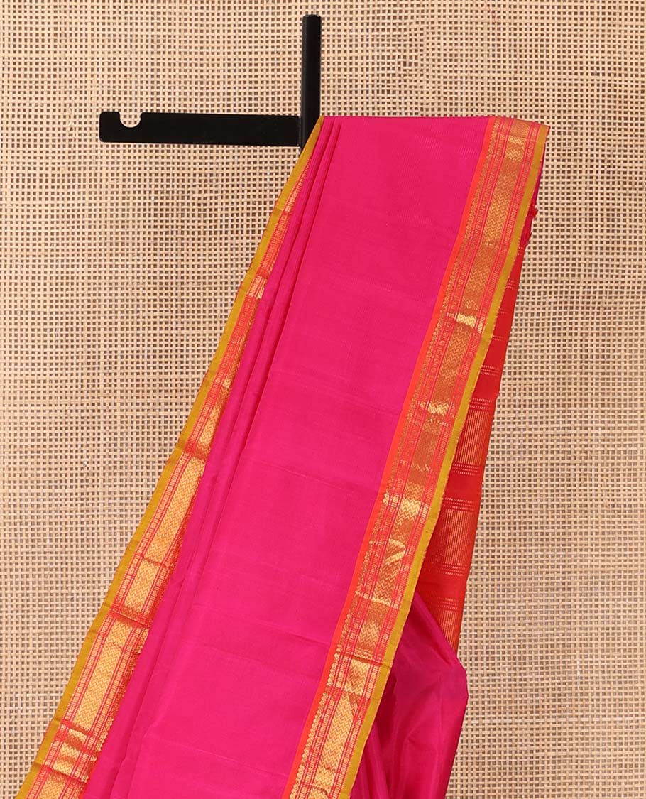 Pink plain Kanchipuram silk saree, contrast border of salngai, muthu, cross kamalam, and vanki designs, and zari design pallu
