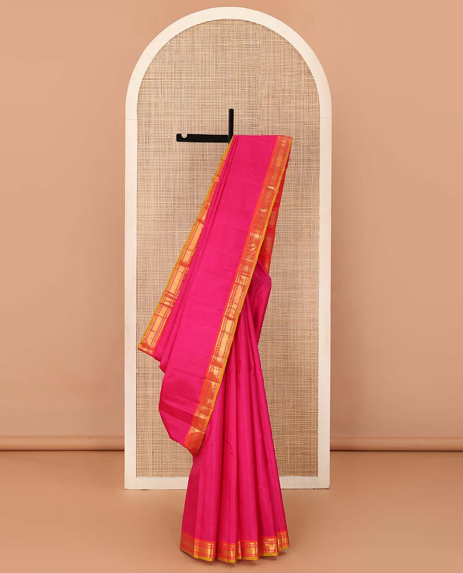 Pink plain Kanchipuram silk saree, contrast border of salngai, muthu, cross kamalam, and vanki designs, and zari design pallu