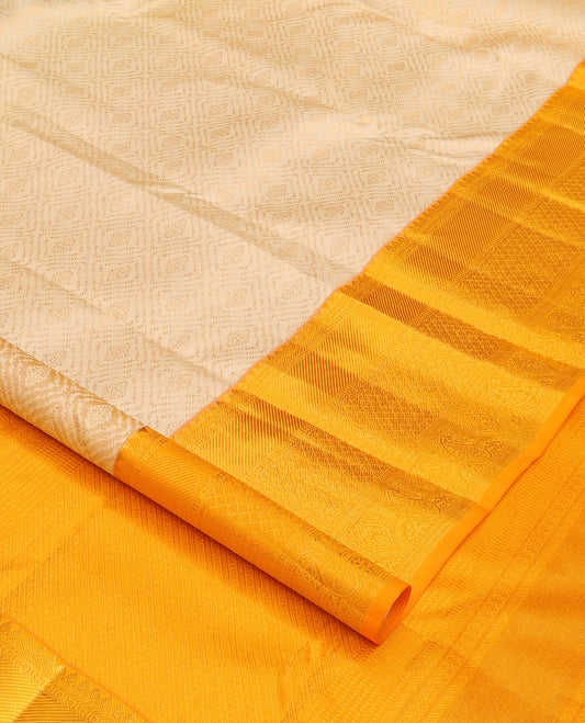 Cream jacquard wedding silk saree, contrast traditional zari design border, and intricate pallu