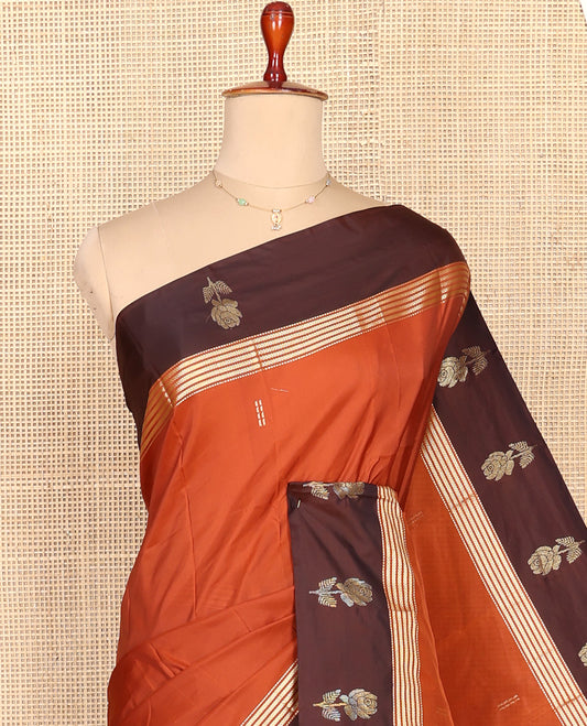Rust Aarani Silk Saree, Adorned with Zari Buttas All Over Its Body, Complemented by a Contrast Zari Border of Floral Motifs, Pallu of Stripes and Buttas, and Paired with a Matching Blouse