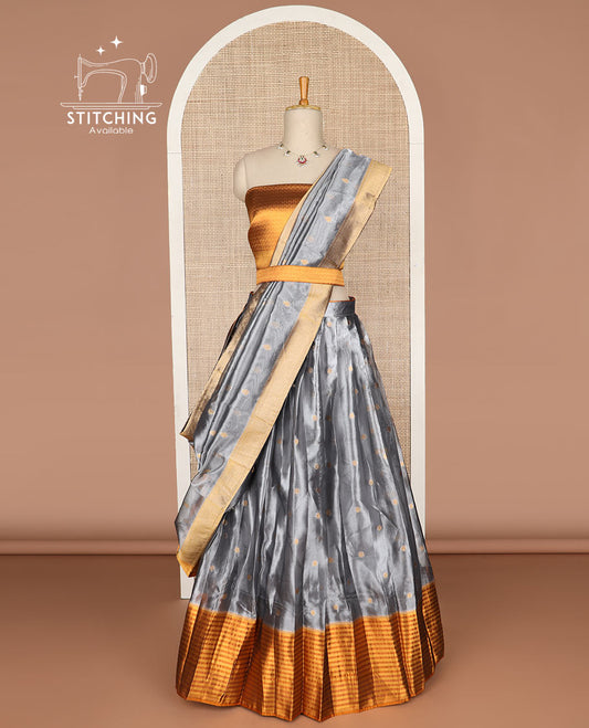 Grey buttas tissue half saree with contrast zari design border, jaal zari design blouse & floral design dhavani