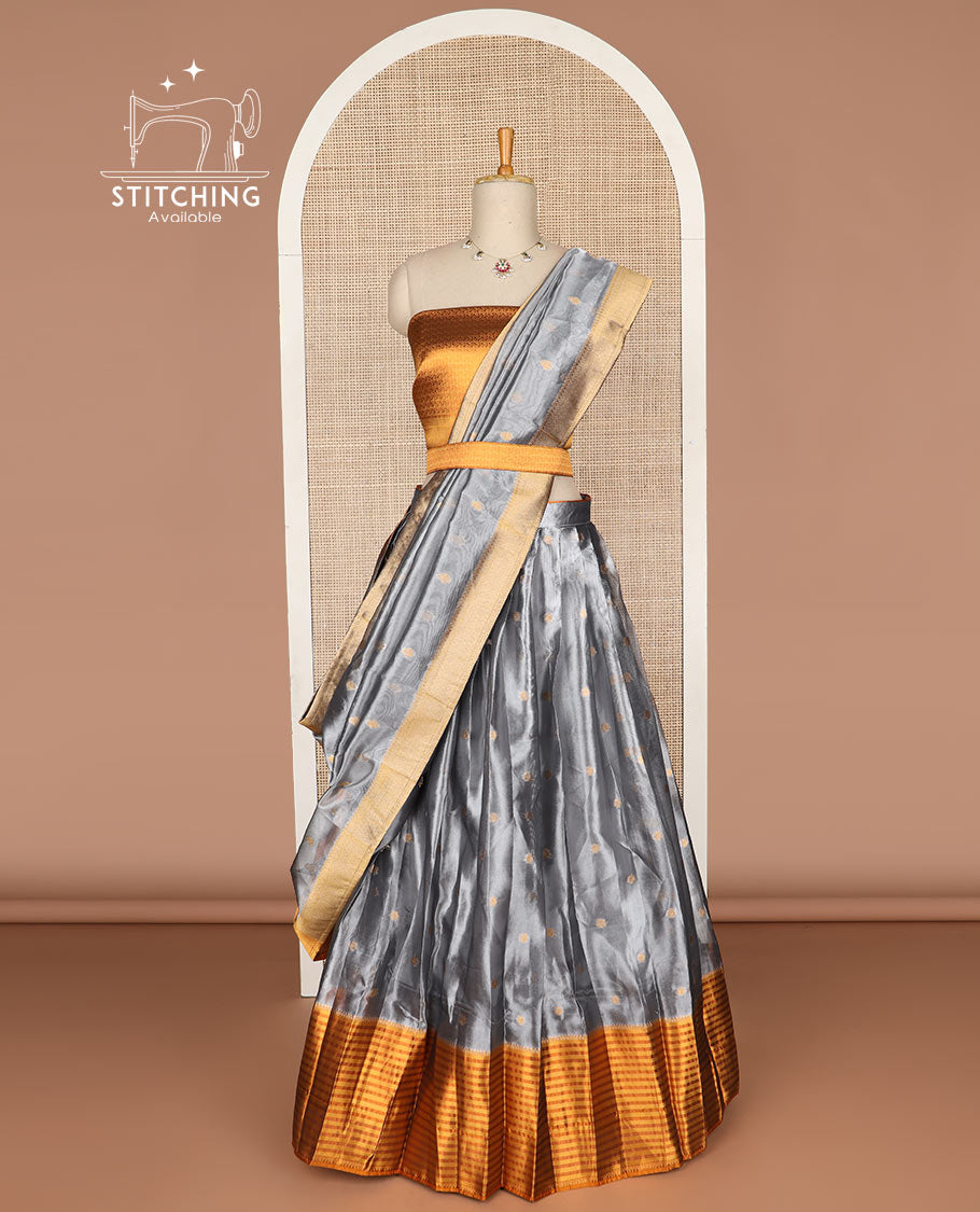 Grey buttas tissue half saree with contrast zari design border, jaal zari design blouse & floral design dhavani