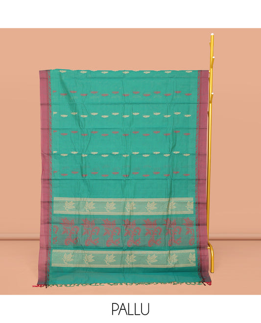 Green Kanchi Cotton Saree, Finely Crafted with Buttas All Over Its Body, Complemented by Contrast Border, Pallu of Floral Designs, and Paired with a Matching Blouse