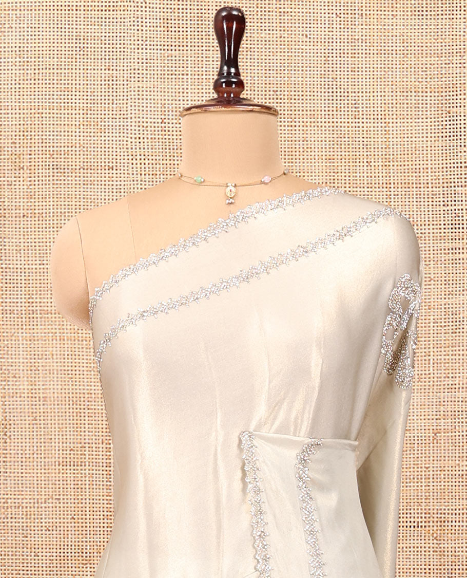Champagne Designer Saree, Spotlighted by Zari Buttas All Over Its Body, Scallop Stone Work Border, and Paired with a Matching Blouse