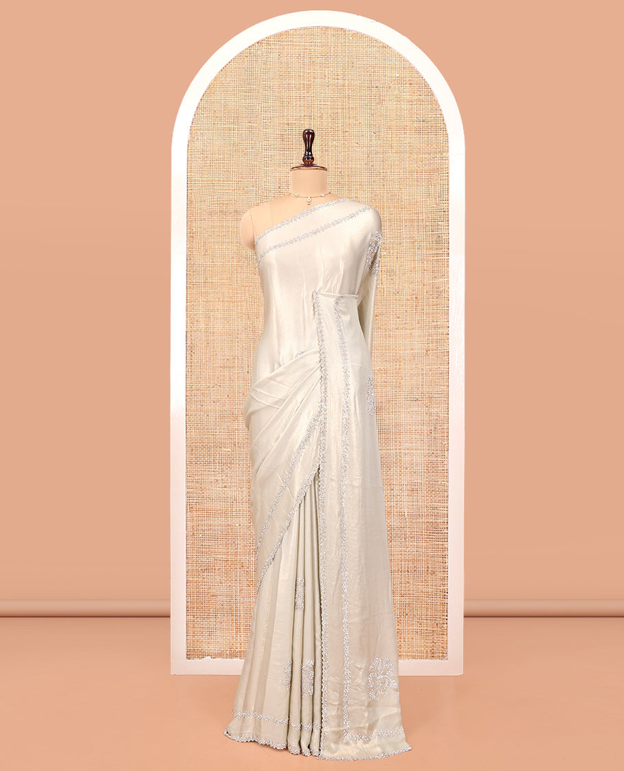 Champagne Designer Saree, Spotlighted by Zari Buttas All Over Its Body, Scallop Stone Work Border, and Paired with a Matching Blouse