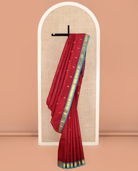 Red Kanchipuram Silk Saree, Mesmerized with Zari Buttas on Its Body, Complemented by a Contrast One-Sided Border of Banaras, and Mayil Kann Designs, Pallu of Zari Designs, and Comes Without a Blouse