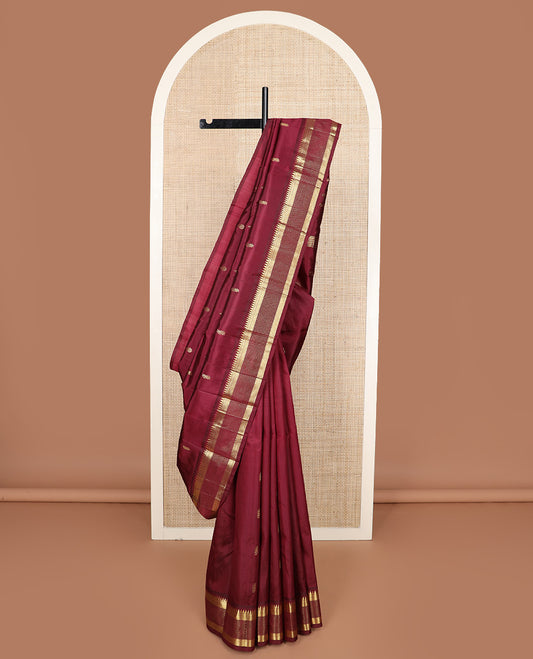 Maroon zari buttas Kanchipuram silk saree, one-sided zari border of thazampoo rekku, banaras, diamond, and muthu stripes, and zari design pallu