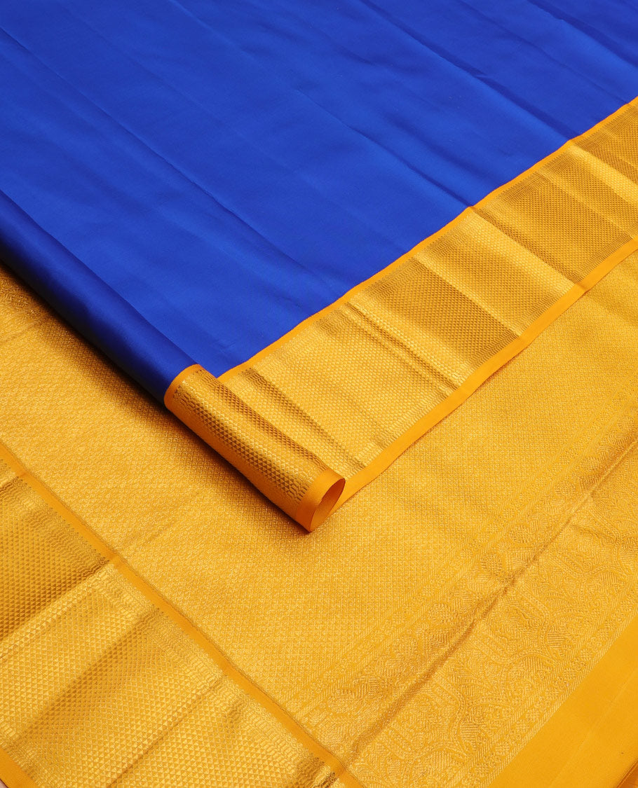 Royal blue plain Kanchipuram silk saree, contrast border of salngai, muthu, and ara maadam designs, and intricate pallu